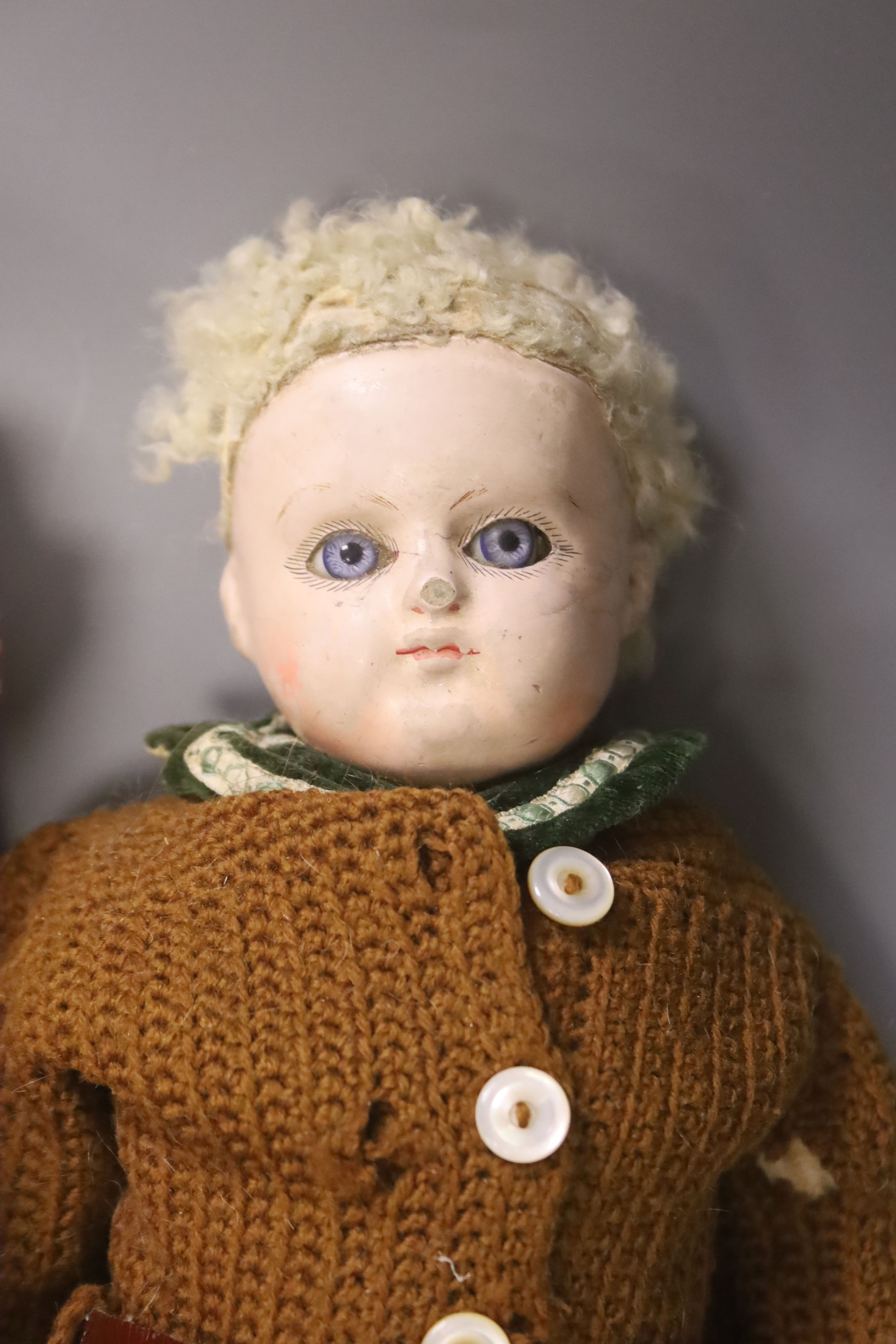 A collection of four dolls including an AM bisque head doll, height 38cm